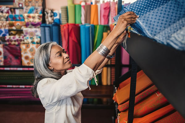 Woman working in her fabric and homewares store